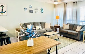Living Space~Cozy sofa's & natural light from windows that flows into kitchen