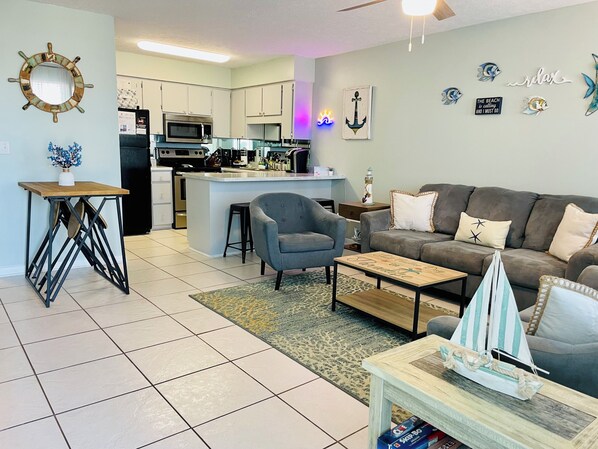Living Space~Cozy sofa's & natural light from windows that flows into kitchen
