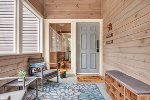 Front Entry_Screened in porch with seating and views of the lake 