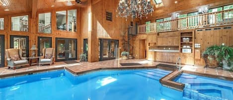 Large indoor pool with attached hot tub