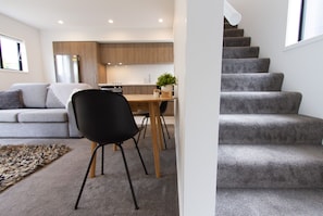 Dining area and stairs leading to 2nd storey with bedroom and bathroom