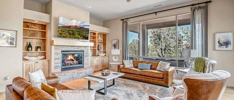 Comfortable Living Room with a Gas Fireplace and Smart TV with Cable