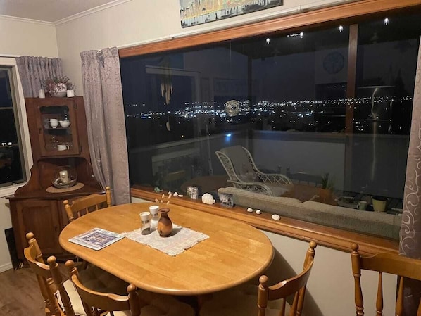 Dining area looking out on deck towards city lights