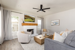 Open living room with designer furnishing and a smart TV.