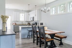 Full functioning kitchen, with dining table.