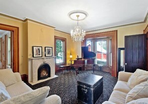 Spacious First Living room with a Piano and Lots of Natural Light.