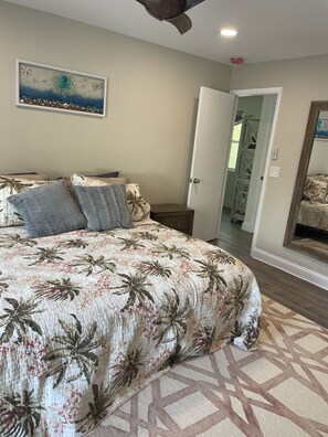 Master bedroom with smart TV and room darkening shades.