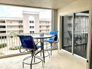 Balcony has sliding doors from both the living room and primary bedroom