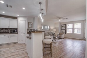 View from the hallway into the kitchen and living room