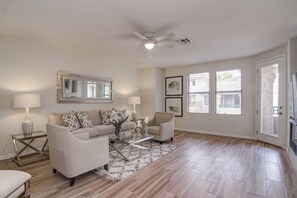 Main gathering room with pull out sofa and 2 chairs for relaxing