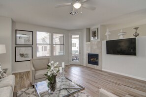 Gas fireplace, 55 inch Smart TV, Sleeper sofa, 2 chairs and access to balcony