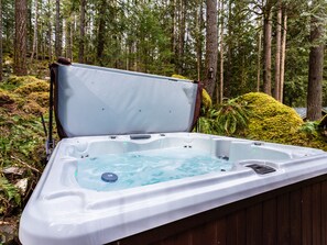 Soak in the hot tub while soaking up nature