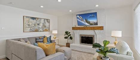 Family room with fireplace, TV, sectional, 2 chairs