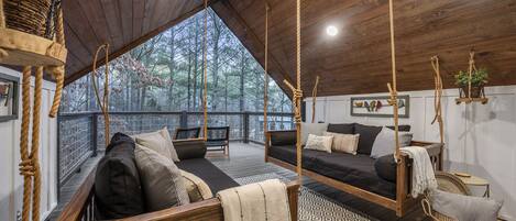 Upstairs patio balcony with rope-swing loveseats.