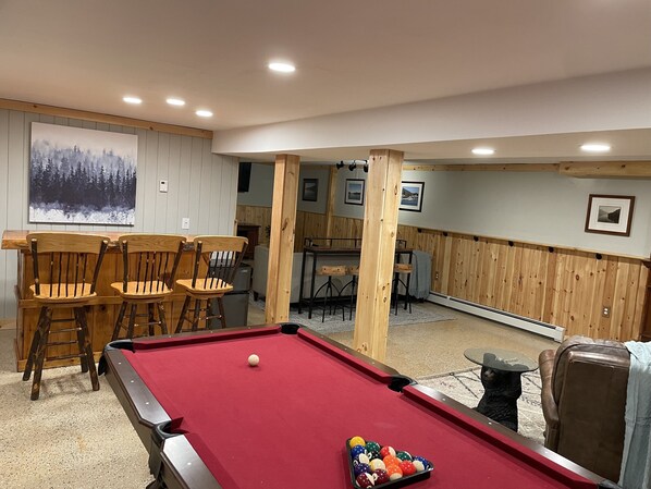 lower level is 1600 sqr ft incl. game room, fireplace, sectional, bar & bedroom.