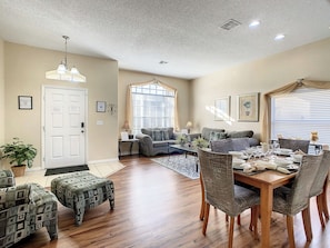 - Spacious open layout with comfy seating perfect for family movie nights or gatherings
- Enjoy meals at the large dining table set for six, ideal for shared vacation dinners
- Warm natural light, stylish furniture, & cozy charm make this space feel like home