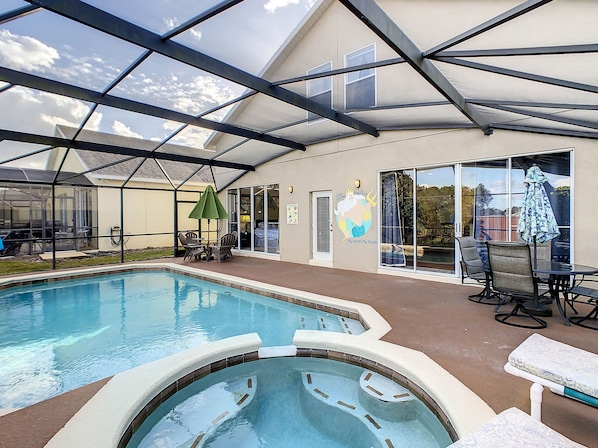 Private pool and spa area with two dining tables.