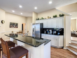 - Fully equipped kitchen with modern appliances and sleek granite counters
- Coffee lovers rejoice, multiple brewers and all your morning essentials in one spot
- Gather around the breakfast bar or dine at the round table for casual meals and laughs