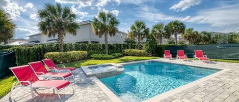 The home includes heated pool and hot tub (POOL HEAT INCLUDED) -A lawned area behind the pool