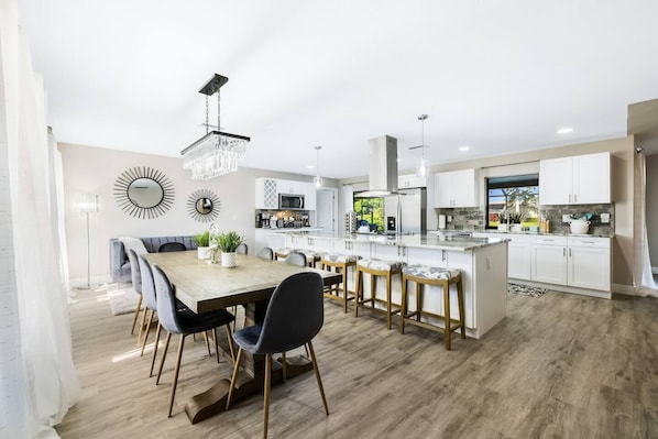 Welcome to Gulf Coast Cabana! This bright, open-concept kitchen and dining area is fully stocked with everything you need, including a cozy coffee bar. Perfect for preparing meals or simply relaxing with your group.