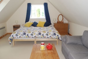 Studio with open plan bed and lounge area, TV, DVDs and books