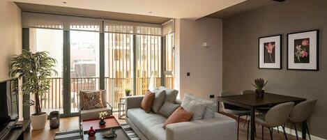 The modern newly designed living room with a private balcony and dining area.