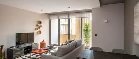 The modern newly designed living room with a private balcony and dining area.