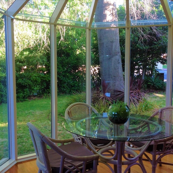 Dining table overlooks the beautiful gardens.