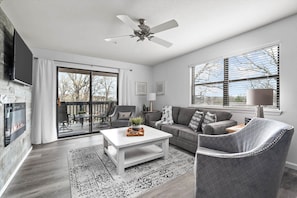 Family room with sleeper sofa, deck.