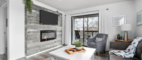 Family room with electric fireplace and 50" smart TV.