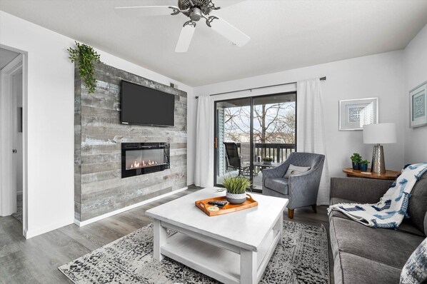 Family room with electric fireplace and 50" smart TV.