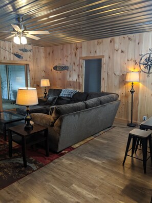 Living room faces the large porch area through sliding glass doors. 