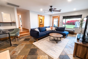 Cozy sunken living room with dedicated office space.