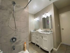Spacious bathroom with bath and shower combo and double vanity