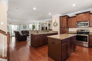 Modern Kitchen has it all Granite Counters and island Stainless appliances hard wood floors