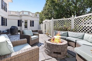 Patio with a gas grill near the pickleball courts