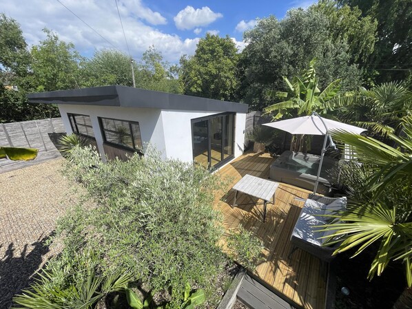 Outside seating area with jacuzzi leading to bifold doors