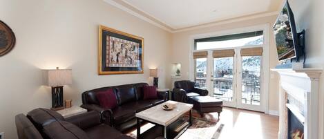 Downtown Durango Condo - Mears 3C. Living room with fireplace, tv, and mountain views. Located right across the street from the historic train.