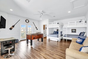 Game room with foosball, Pacman, sofa, and bunk beds