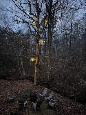 Part of the chandelier garden is in the big tree behind the Crooked Tree Cabin. Enjoy a whimsical view and starlit sky while making s’mores and relaxing around the wood burning fire pit.