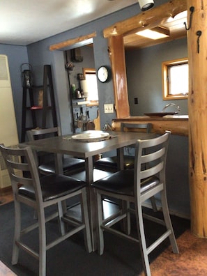 Dining/kitchenette cove in back; sink, stove/oven, & a wide array of cookware.