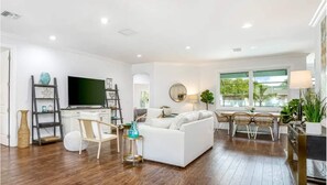 Living Room with 70" TV and queen sofa sleeper.