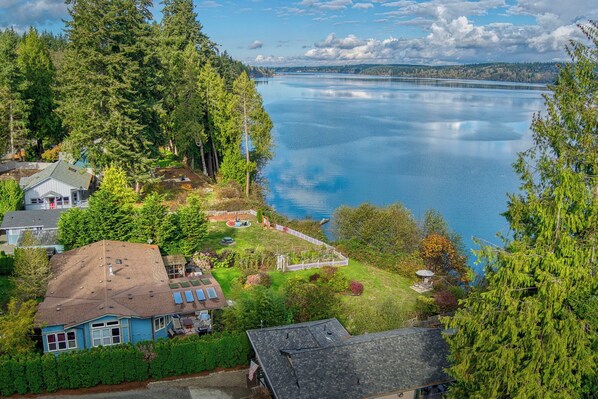 Enjoy quiet beauty of gardens with  fruit trees situated above the bay