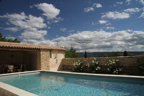 Pool towards pool house and view of Luberon hills
