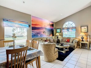 - Lounge in style with elegant seating, ocean themed art, and warm coastal vibes
- Large windows and bold beach murals flood the space with natural light and charm
- Perfect blend of comfort and personality, ideal for gathering and relaxing
