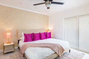 Easy access to outdoor space from the cheerful master bedroom with blackout curtains