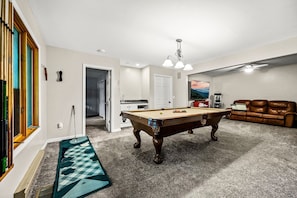 Game room adjacent to both the kids bunk rooms and the lower level master suite
