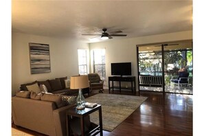 Spacious living area with lots of seating and large flat-screen TV and 
