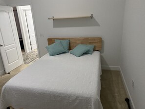 Queen bed in one of three bedrooms