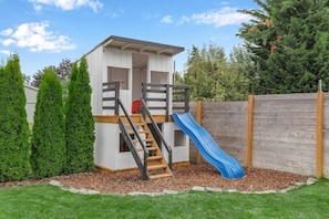 A double-decker outdoor playhouse for kids that comes equipped with a kitchen playset? Sign us up (and our kids)!